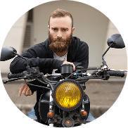portrait-young-brutal-man-sitting-motorcycle-outdoors-min